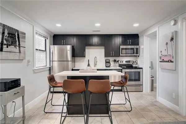 a kitchen with stainless steel appliances a refrigerator a stove a sink and a refrigerator