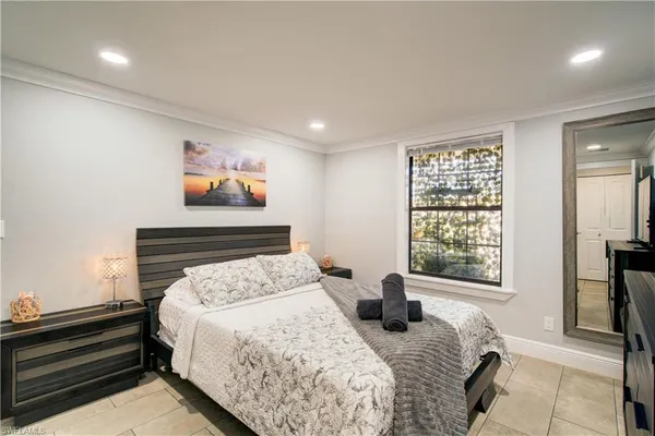 a bedroom with a bed and glass windows