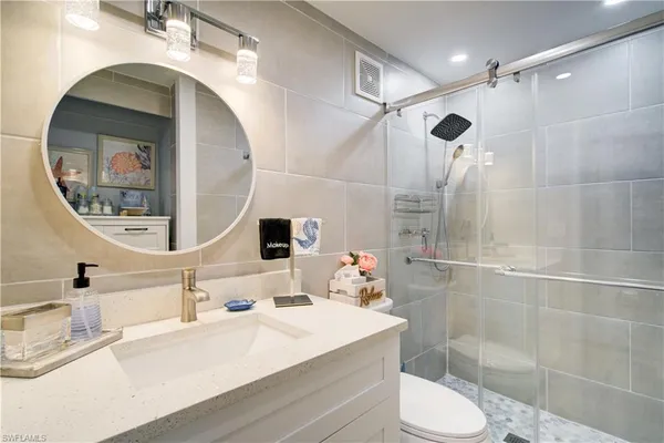 a bathroom with a sink toilet and shower