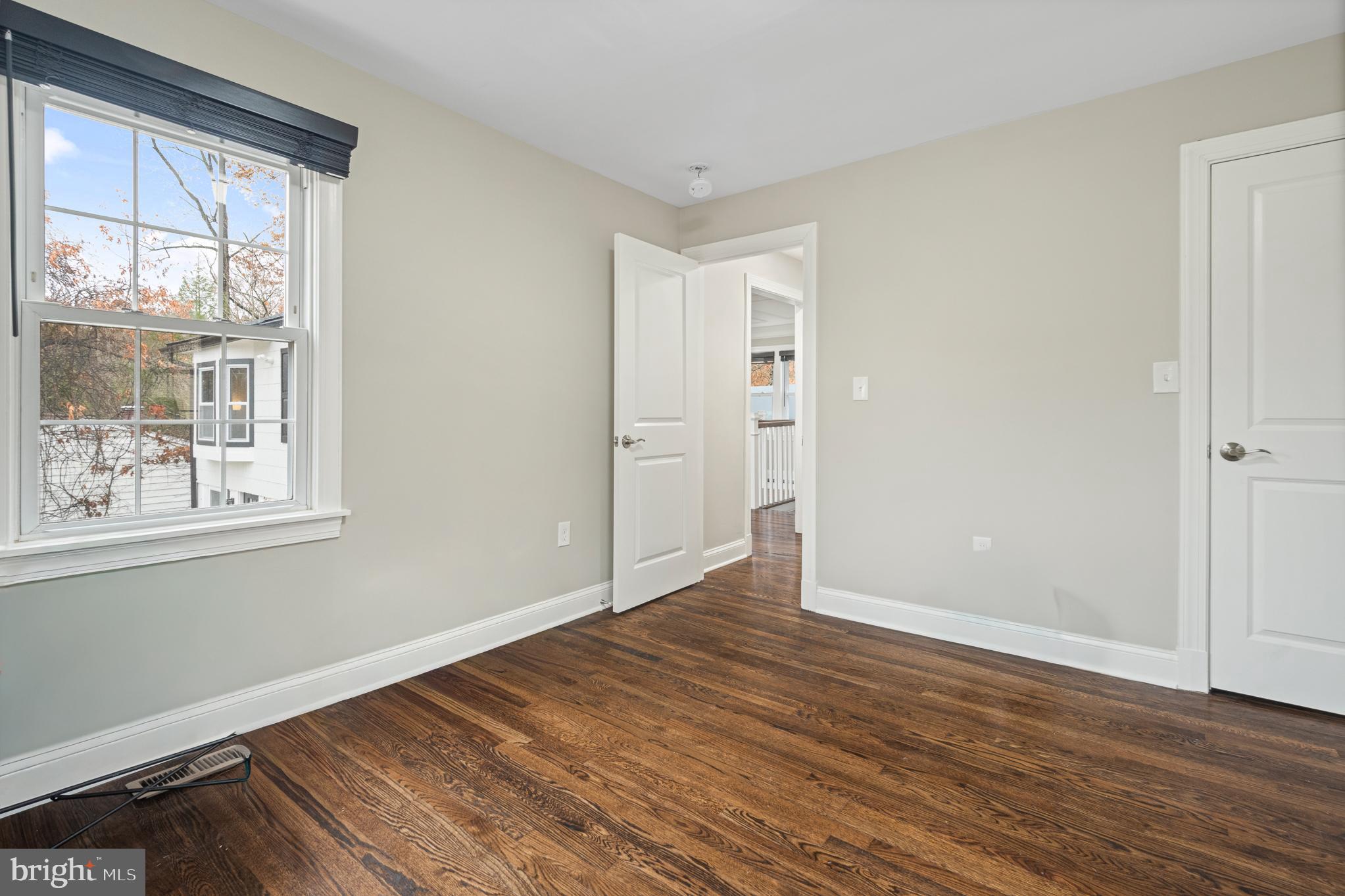 9217 Fowler Lane Lanham, MD 20706 - Photo 28 of 80 a view of an empty room with wooden floor and a window