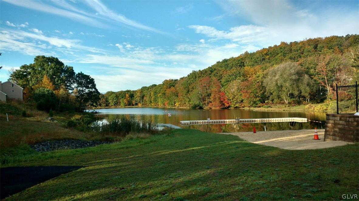 239 Saunders Drive Bushkill, PA 18324 - Photo 18 of 26 a view of a lake with houses in the background