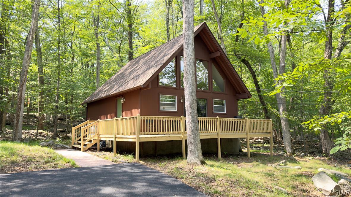 239 Saunders Drive Bushkill, PA 18324 - Photo 5 of 26 a view of a house with a balcony and door