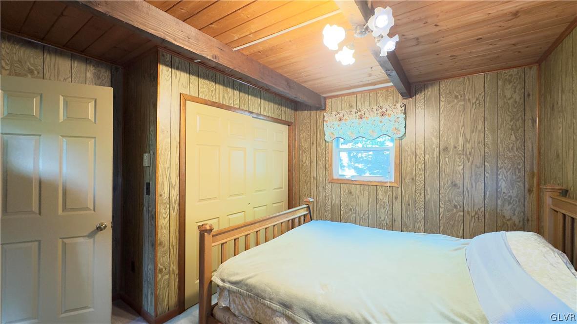 239 Saunders Drive Bushkill, PA 18324 - Photo 10 of 26 a bedroom with a bed and a window