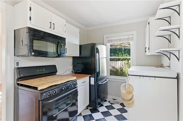 a kitchen with a stove a refrigerator and a sink