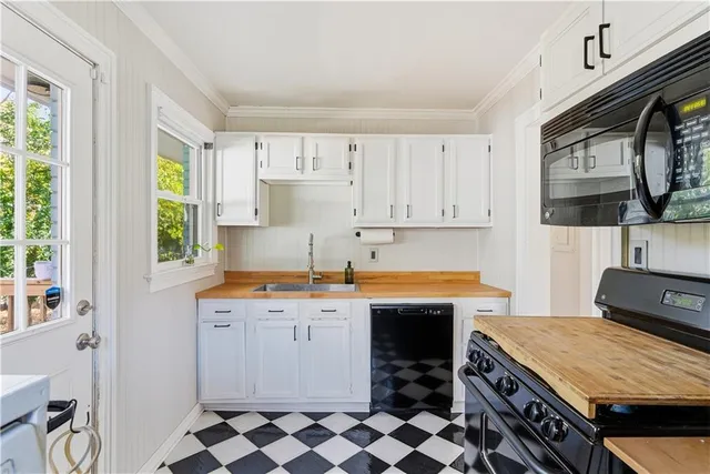 a kitchen that has a sink and a stove in it