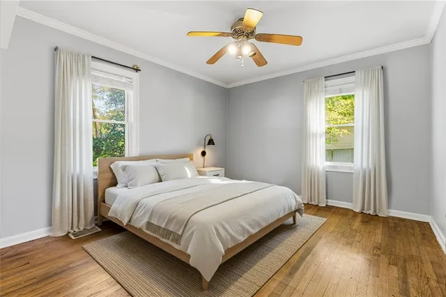 a bedroom with a bed a window and a chandelier