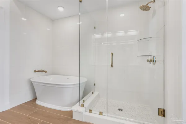 a spacious bathroom with a double vanity sink a mirror and a shower