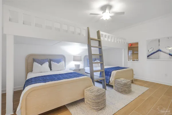 a bedroom with two beds and painting on the wall