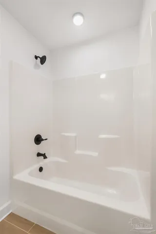 a balcony with wooden floor and furniture