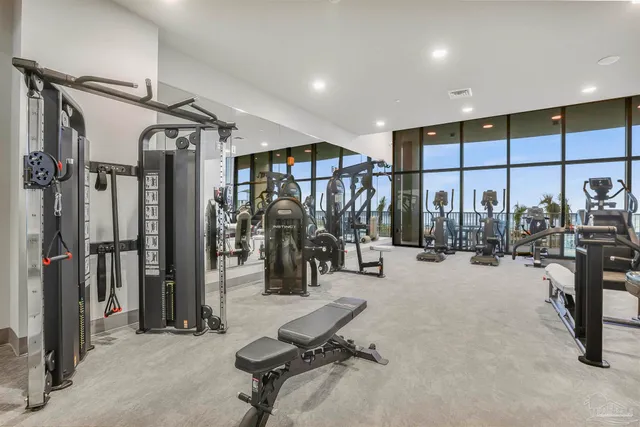 a large white kitchen with a large window and chandelier