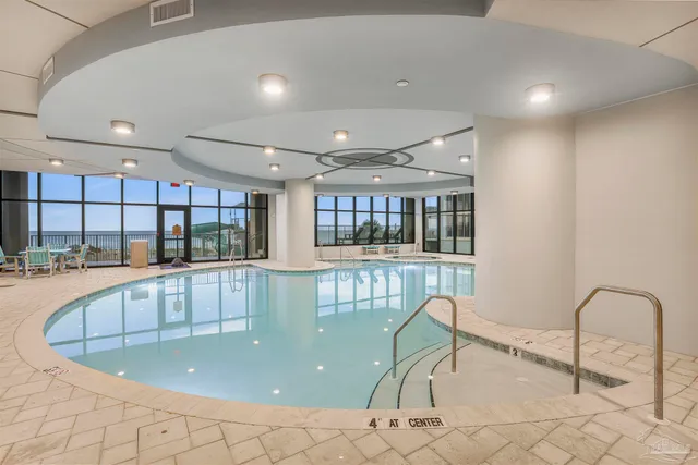 a dining room with furniture and a floor to ceiling window