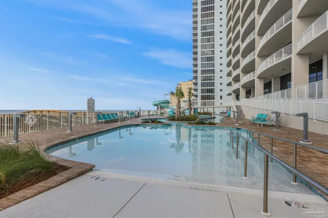 a view of swimming pool with building in the background