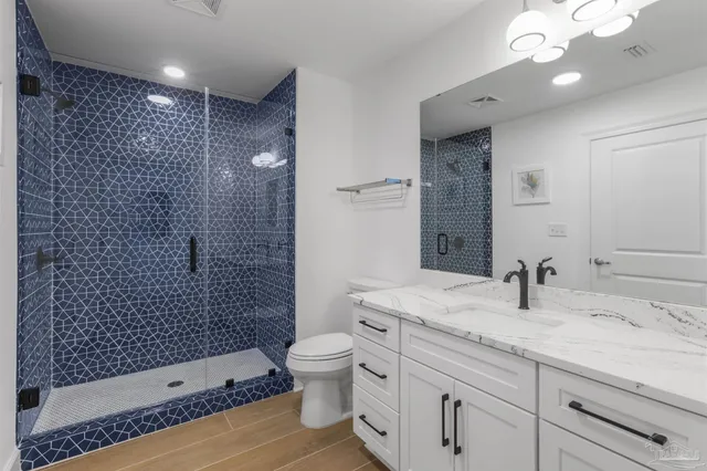 a kitchen with stainless steel appliances kitchen island granite countertop a table chairs a sink a stove a microwave and cabinets