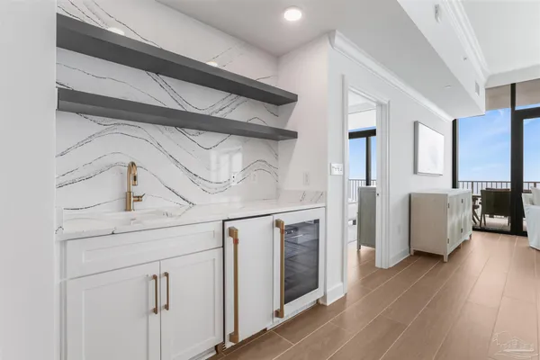 a large white kitchen with a large counter top and stainless steel appliances