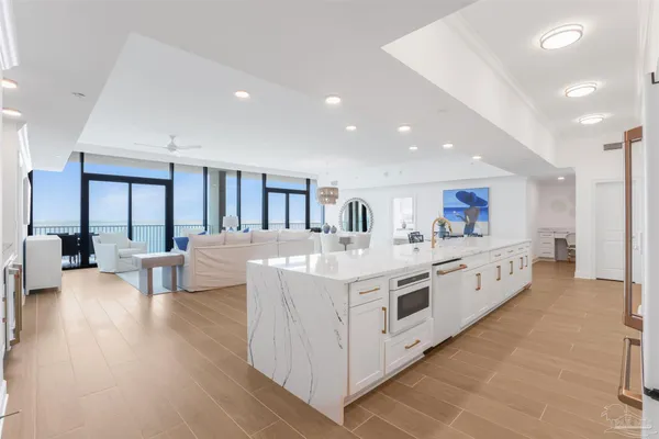 a kitchen with granite countertop white cabinets and stainless steel appliances