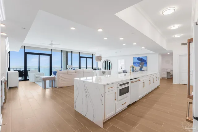 a kitchen with granite countertop white cabinets and stainless steel appliances