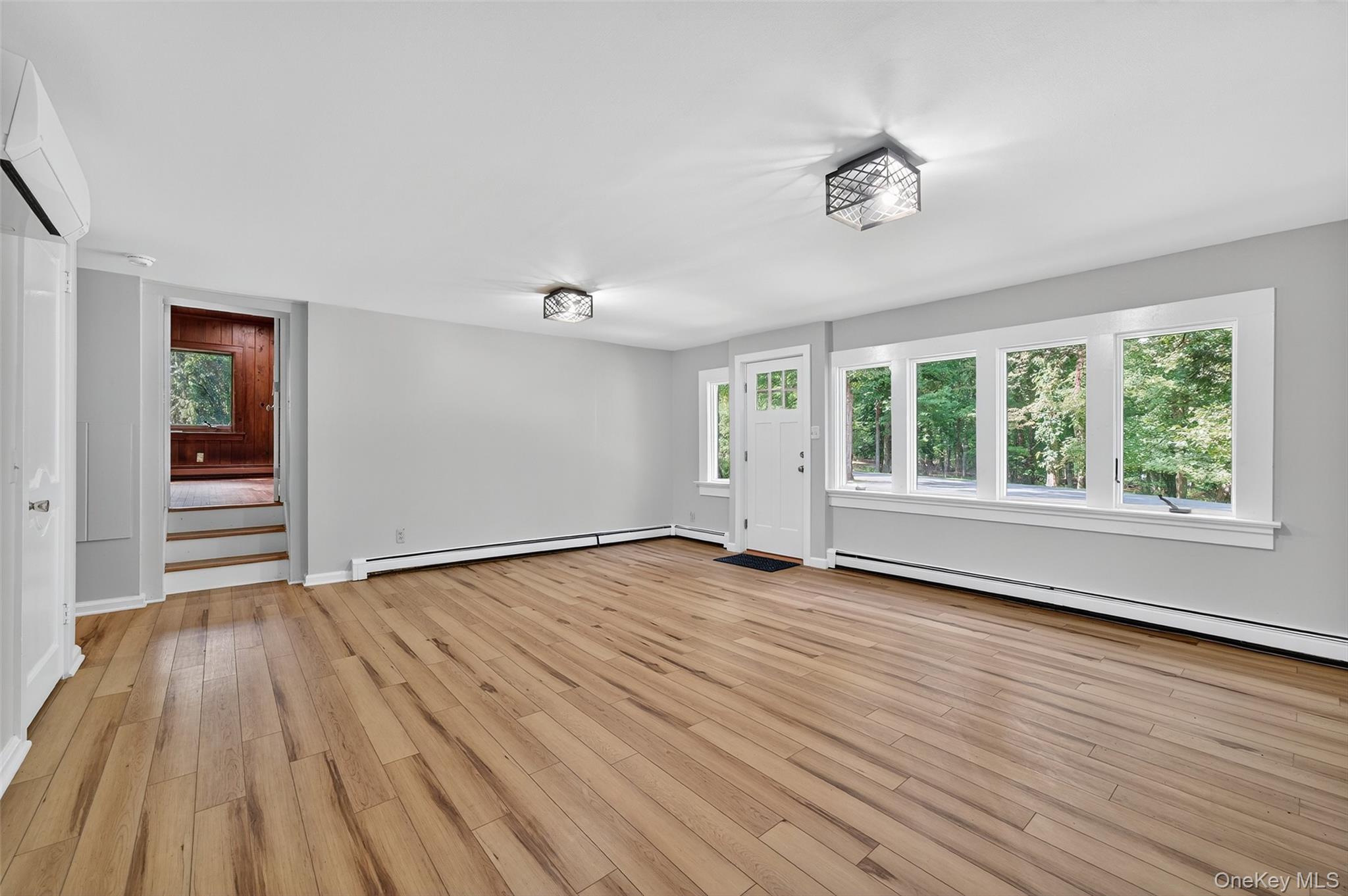 91 Sleepy Valley Road Warwick, NY 10990 - Photo 7 of 30 a view of an empty room with wooden floor and a window