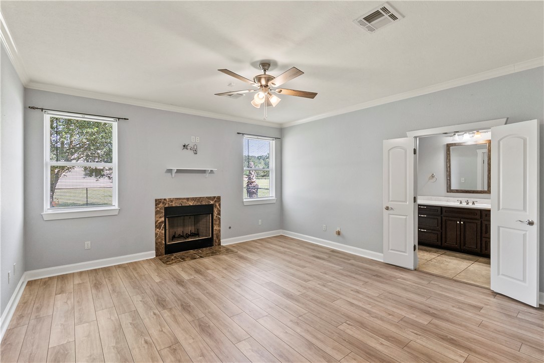 6701 Old Reliance Road Bryan, TX 77808 - Photo 17 of 44 an empty room with windows and a fireplace