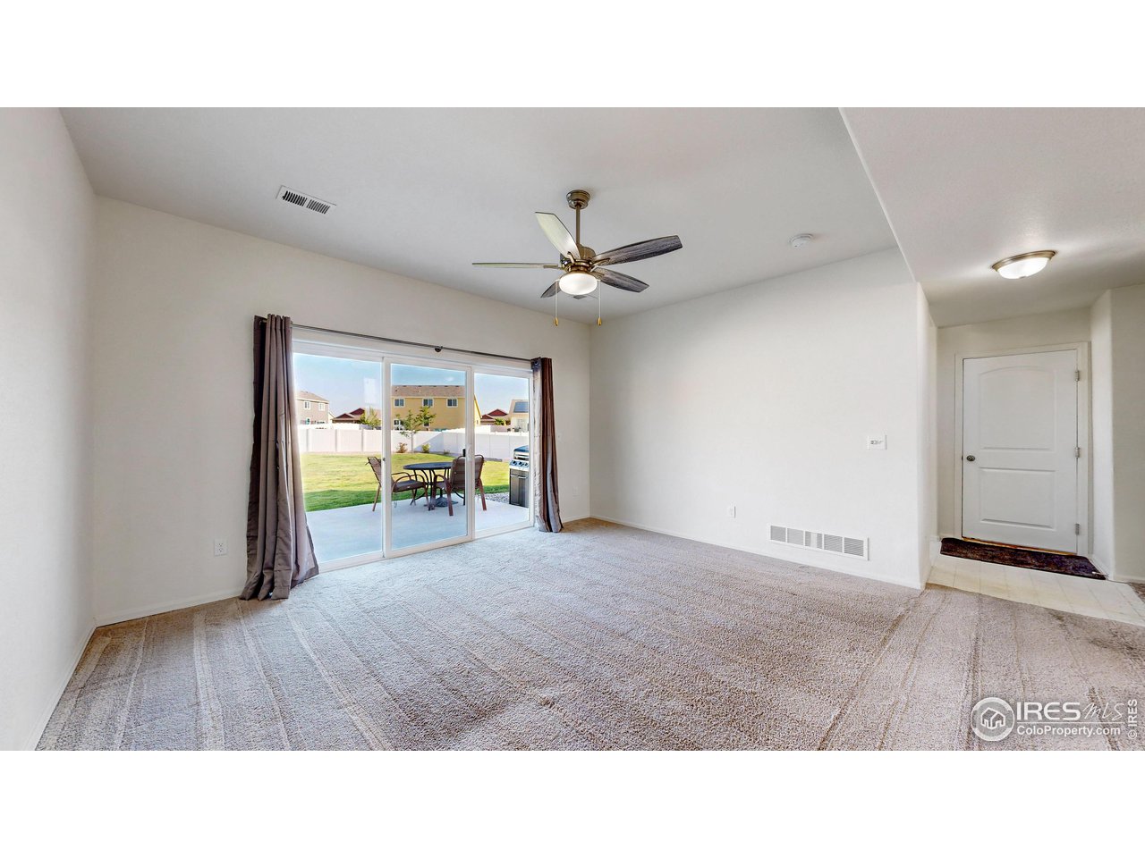 684 Takin Drive Severance, CO 80550 - Photo 11 of 38 a living room with furniture and a large window