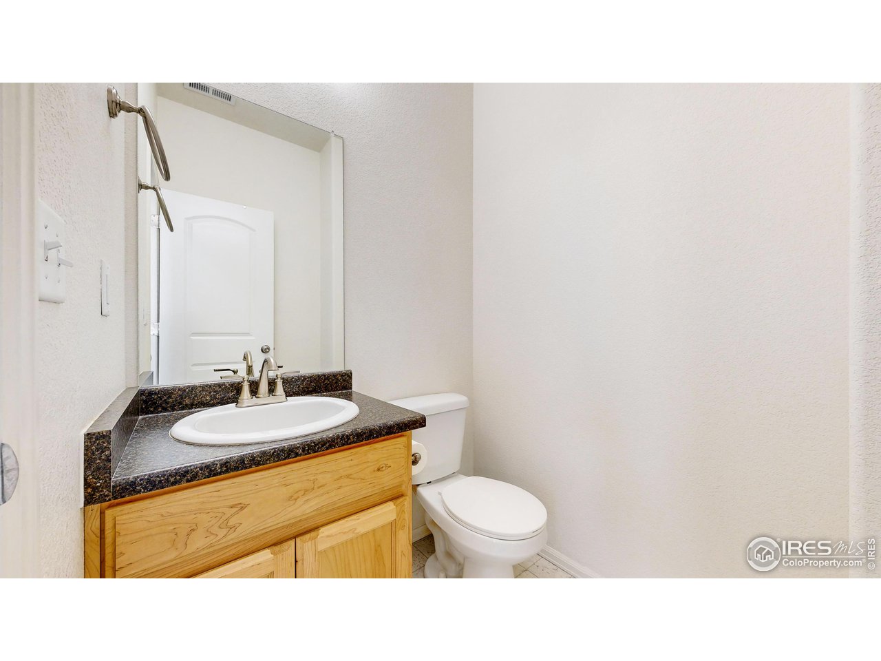 684 Takin Drive Severance, CO 80550 - Photo 13 of 38 a bathroom with a sink a toilet and mirror