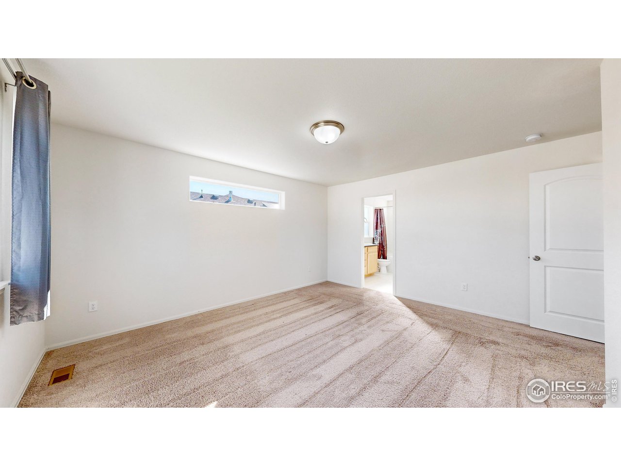 684 Takin Drive Severance, CO 80550 - Photo 23 of 38 a room with a bed and a painting on the wall