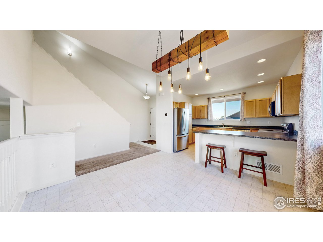 684 Takin Drive Severance, CO 80550 - Photo 5 of 38 a open kitchen with cabinets and stainless steel appliances