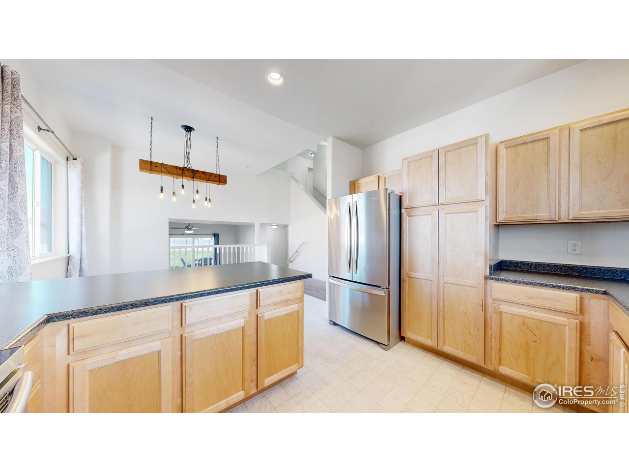 684 Takin Drive Severance, CO 80550 - Photo 7 of 38 a kitchen with stainless steel appliances a refrigerator and a stove top oven
