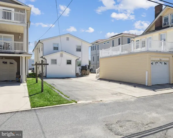 a front view of a building with a garden