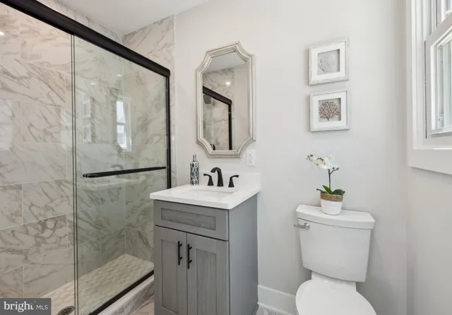 a bathroom with a toilet sink and mirror
