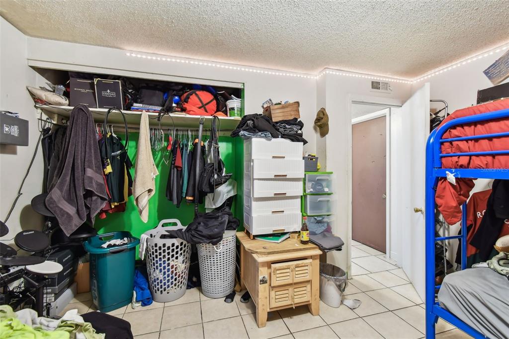 1805 East 139th Avenue, Unit 1 Tampa, FL 33613 - Photo 13 of 44 a view of walk in closet with clothes and shoes
