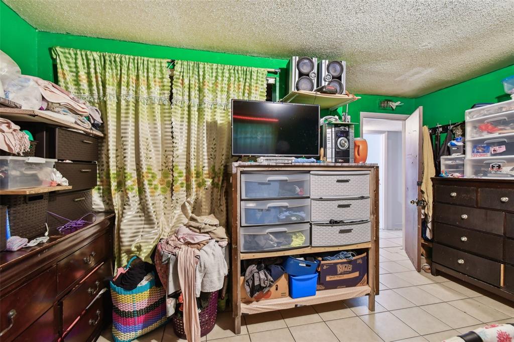 1805 East 139th Avenue, Unit 1 Tampa, FL 33613 - Photo 16 of 44 a room with furniture a flat screen tv and a window