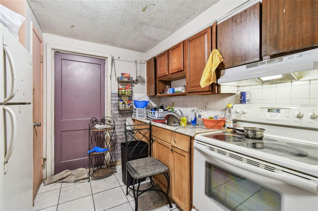 1805 East 139th Avenue, Unit 1 Tampa, FL 33613 - Photo 2 of 44 a view of a kitchen with appliances and cabinets