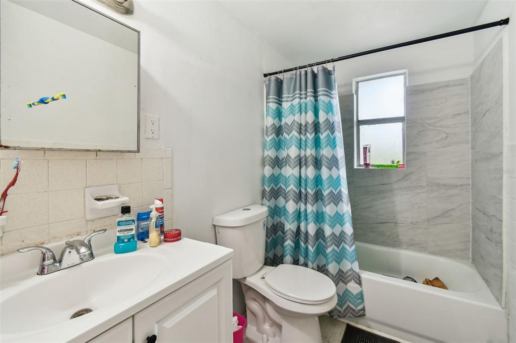 1805 East 139th Avenue, Unit 1 Tampa, FL 33613 - Photo 21 of 44 a bathroom with a sink toilet and shower