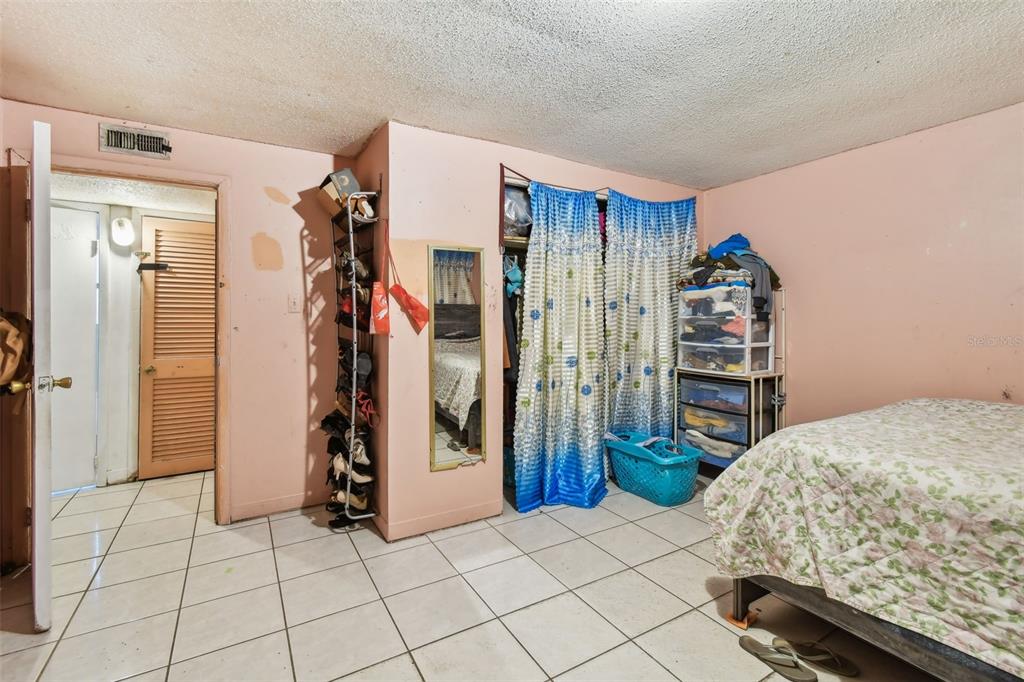 1805 East 139th Avenue, Unit 1 Tampa, FL 33613 - Photo 23 of 44 a bedroom with a bed and a walk in closet