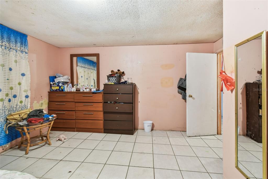 1805 East 139th Avenue, Unit 1 Tampa, FL 33613 - Photo 24 of 44 a room with furniture a rug and a window