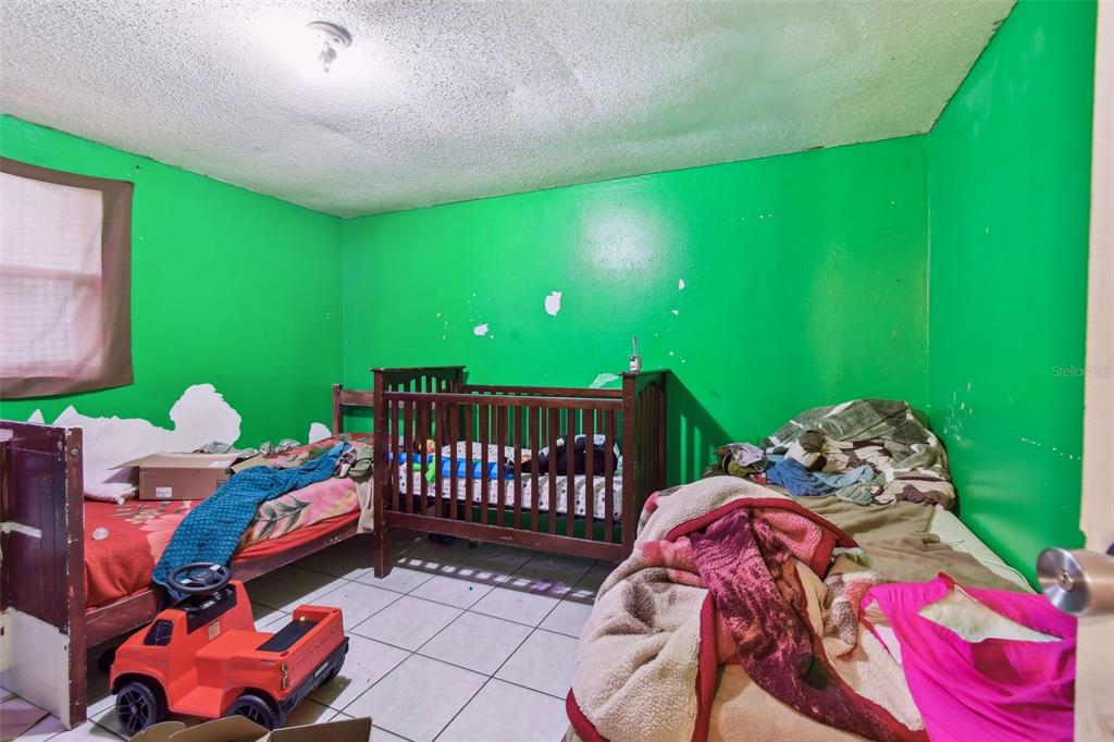 1805 East 139th Avenue, Unit 1 Tampa, FL 33613 - Photo 25 of 44 a bedroom with a bed and a window