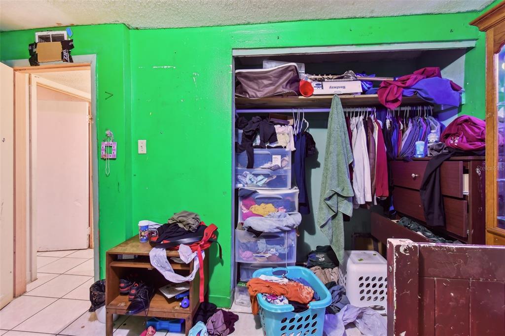 1805 East 139th Avenue, Unit 1 Tampa, FL 33613 - Photo 26 of 44 a room that has a bed and a chair in it