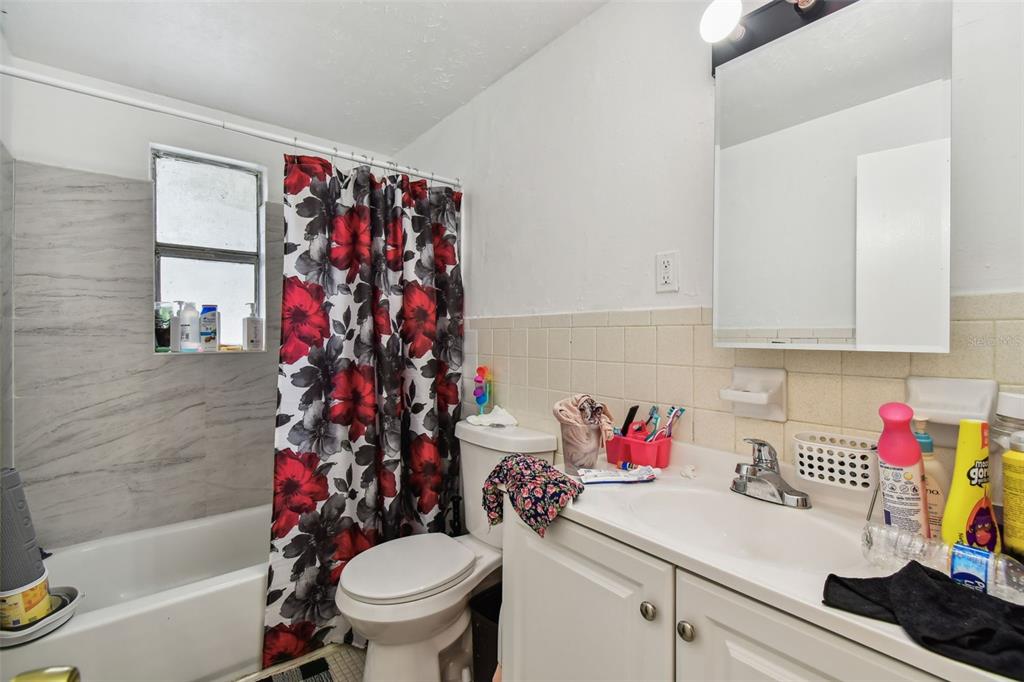 1805 East 139th Avenue, Unit 1 Tampa, FL 33613 - Photo 3 of 44 a bathroom with a sink toilet and a bathtub