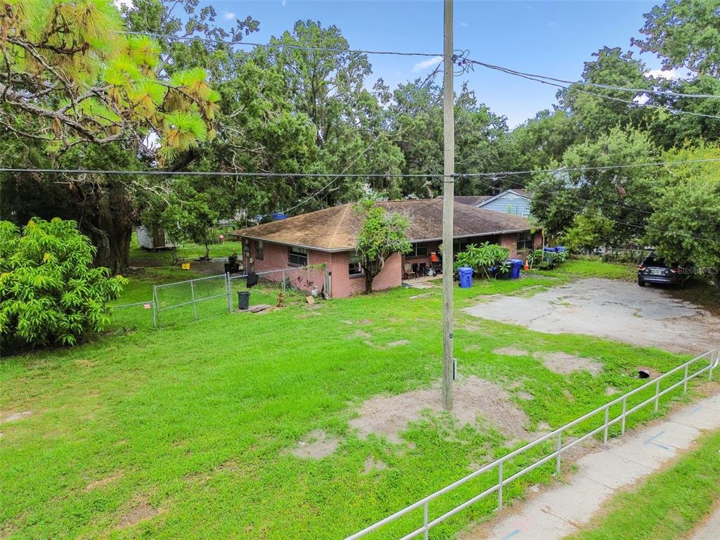 1805 East 139th Avenue, Unit 1 Tampa, FL 33613 - Photo 37 of 44 a view of a house with a backyard and a park