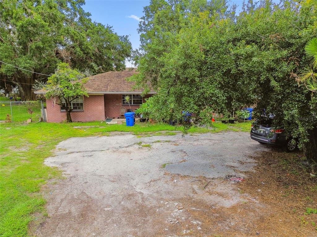 1805 East 139th Avenue, Unit 1 Tampa, FL 33613 - Photo 39 of 44 a view of a house with a yard and tree s