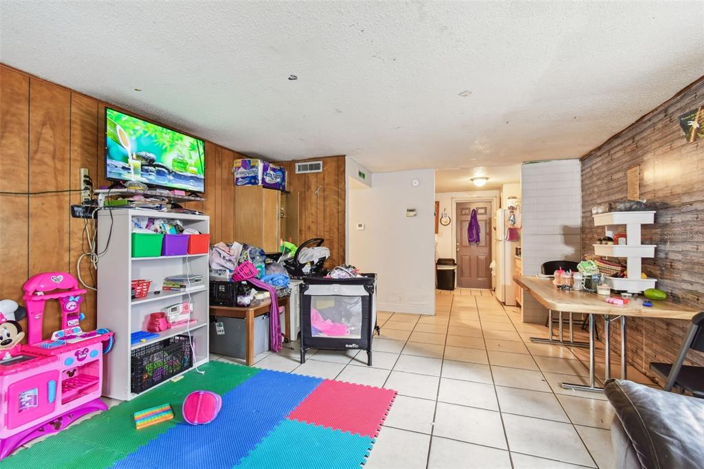 1805 East 139th Avenue, Unit 1 Tampa, FL 33613 - Photo 6 of 44 a view of kitchen with fridge and dining table