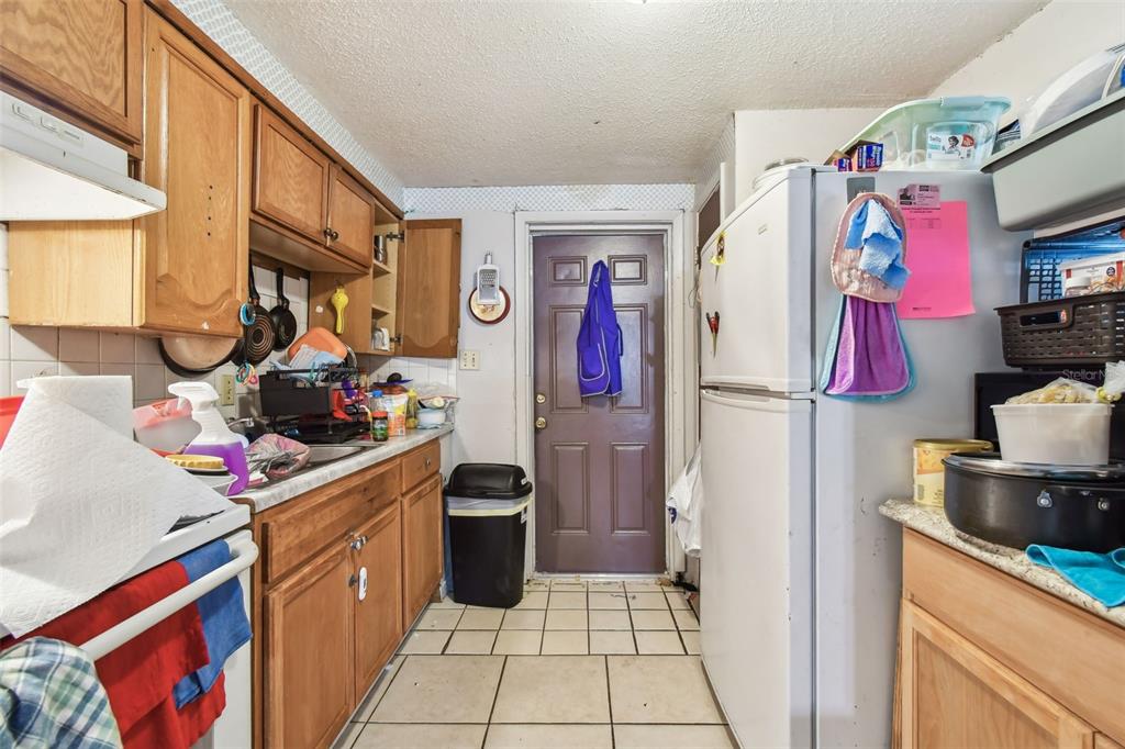 1805 East 139th Avenue, Unit 1 Tampa, FL 33613 - Photo 9 of 44 a kitchen with stainless steel appliances granite countertop a stove and a refrigerator
