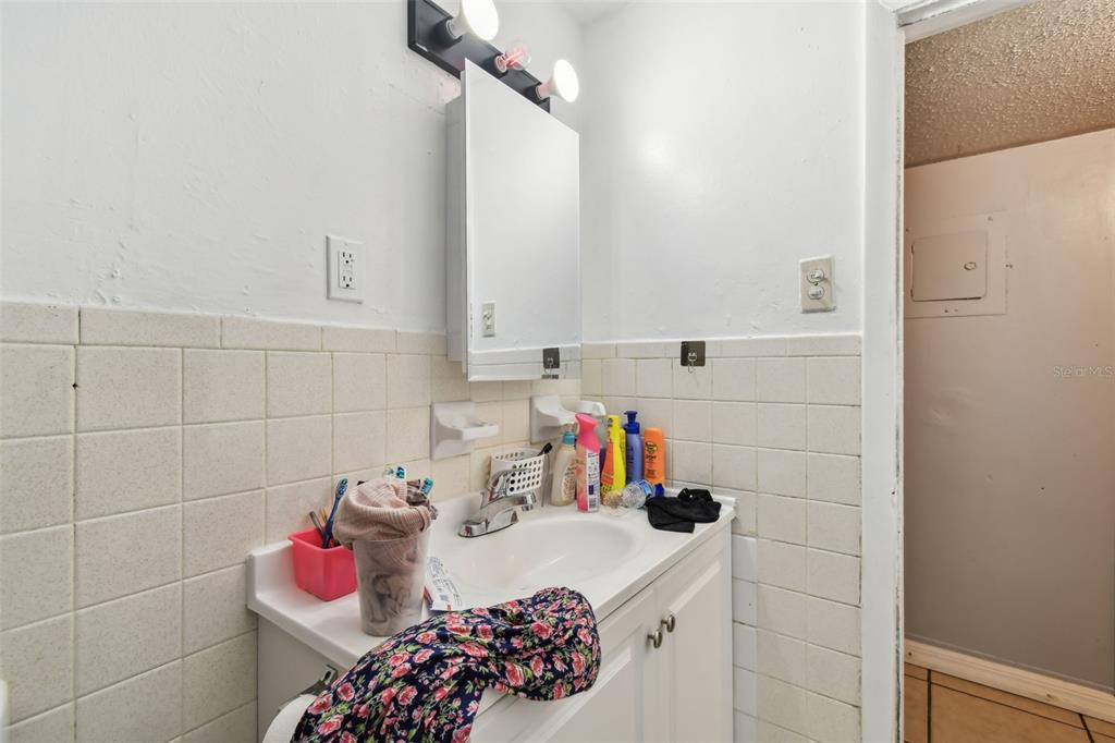 1805 East 139th Avenue, Unit 1 Tampa, FL 33613 - Photo 10 of 44 a bathroom with a sink and a shower