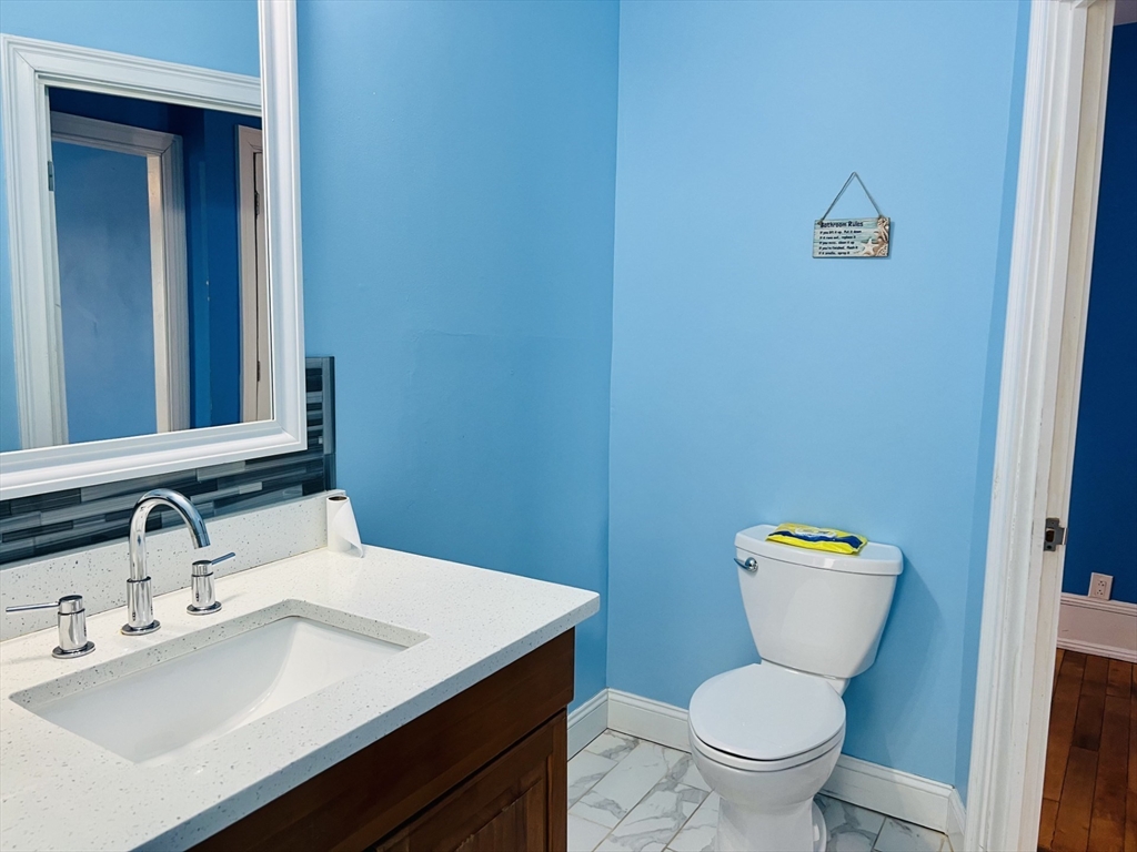 249 Chatham Street Lynn, MA 01902 - Photo 16 of 42 a bathroom with a toilet a sink and mirror