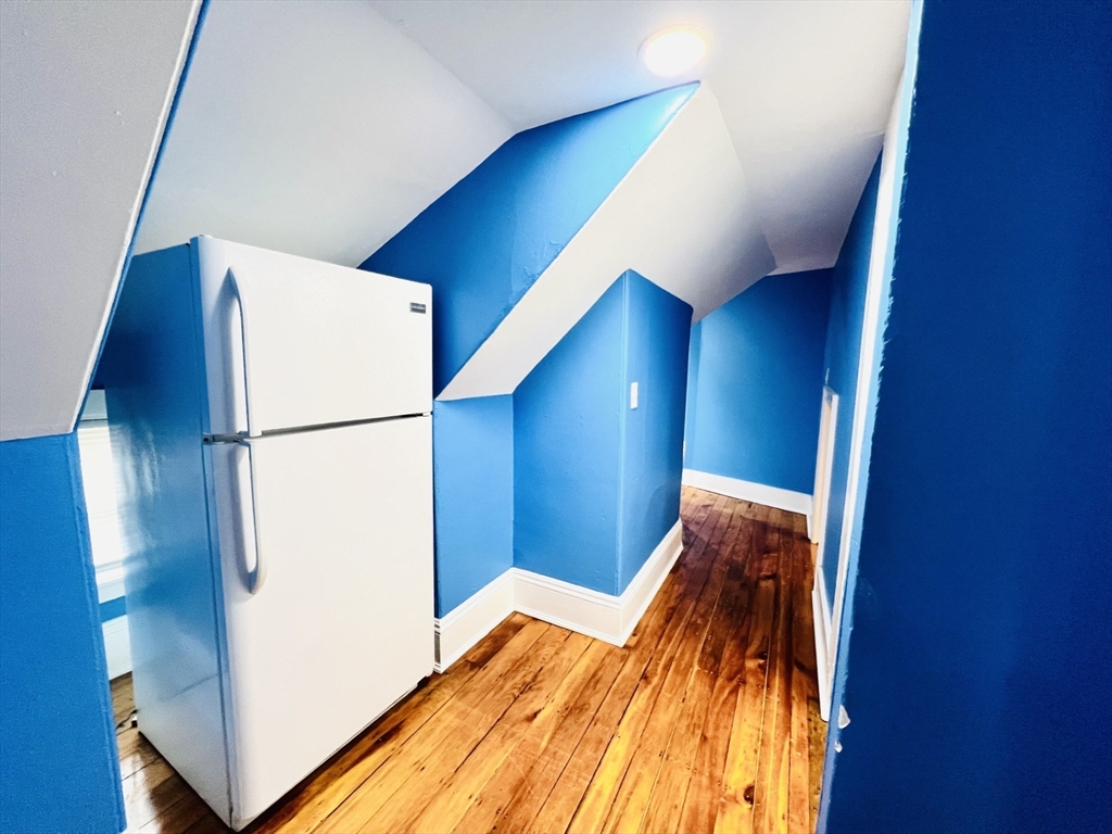 249 Chatham Street Lynn, MA 01902 - Photo 22 of 42 a bedroom with a bed and a refrigerator