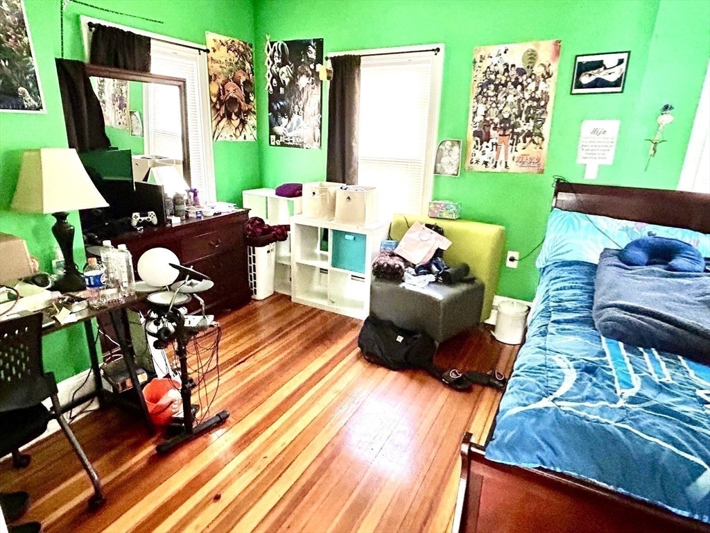249 Chatham Street Lynn, MA 01902 - Photo 31 of 42 a living room with furniture floor to ceiling window and a flat screen tv