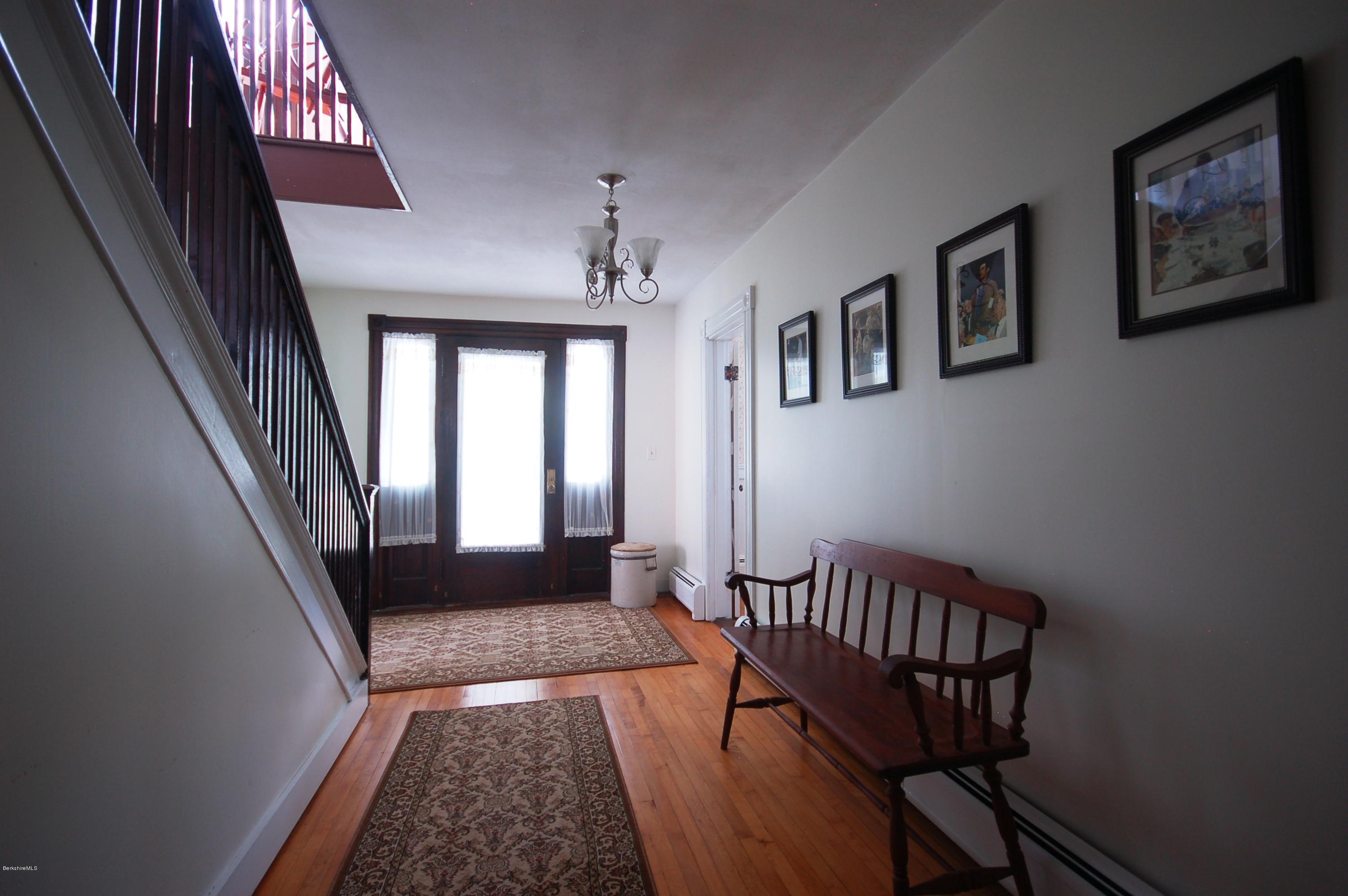 134 West Center Road West Stockbridge, MA 01266 - Photo 16 of 28 a view of a hallway to a livingroom with wooden floor and furniture