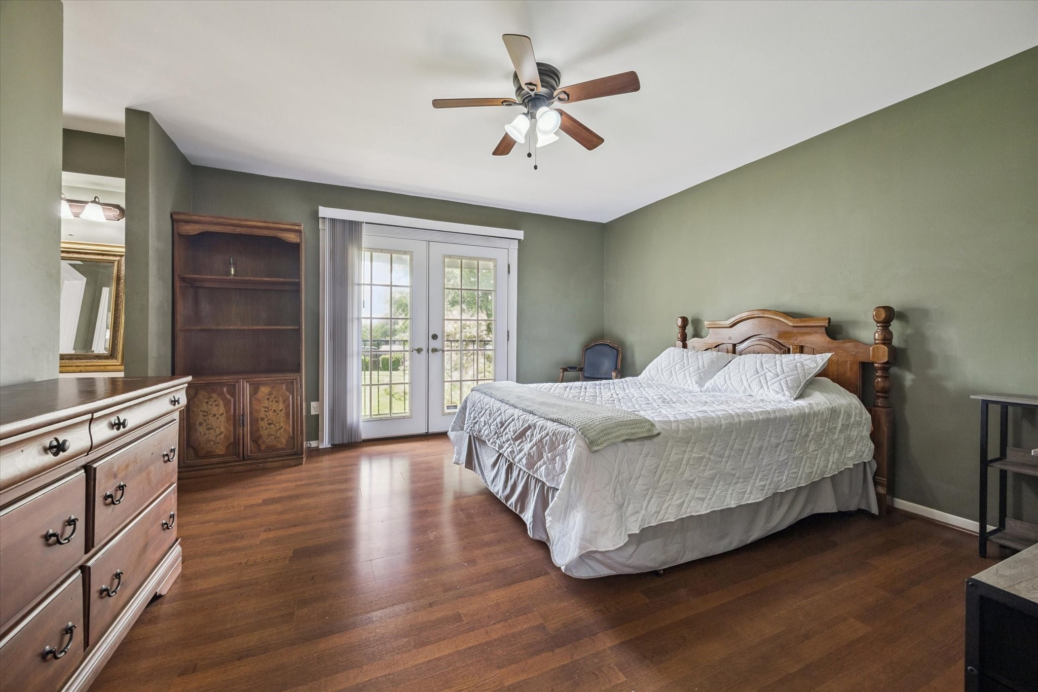 6517 Wanda Lane Houston, TX 77074 - Photo 18 of 29 Welcome to your SPACIOUS primary bedroom! The French doors lead to a private balcony overlooking the green space in front of the home.