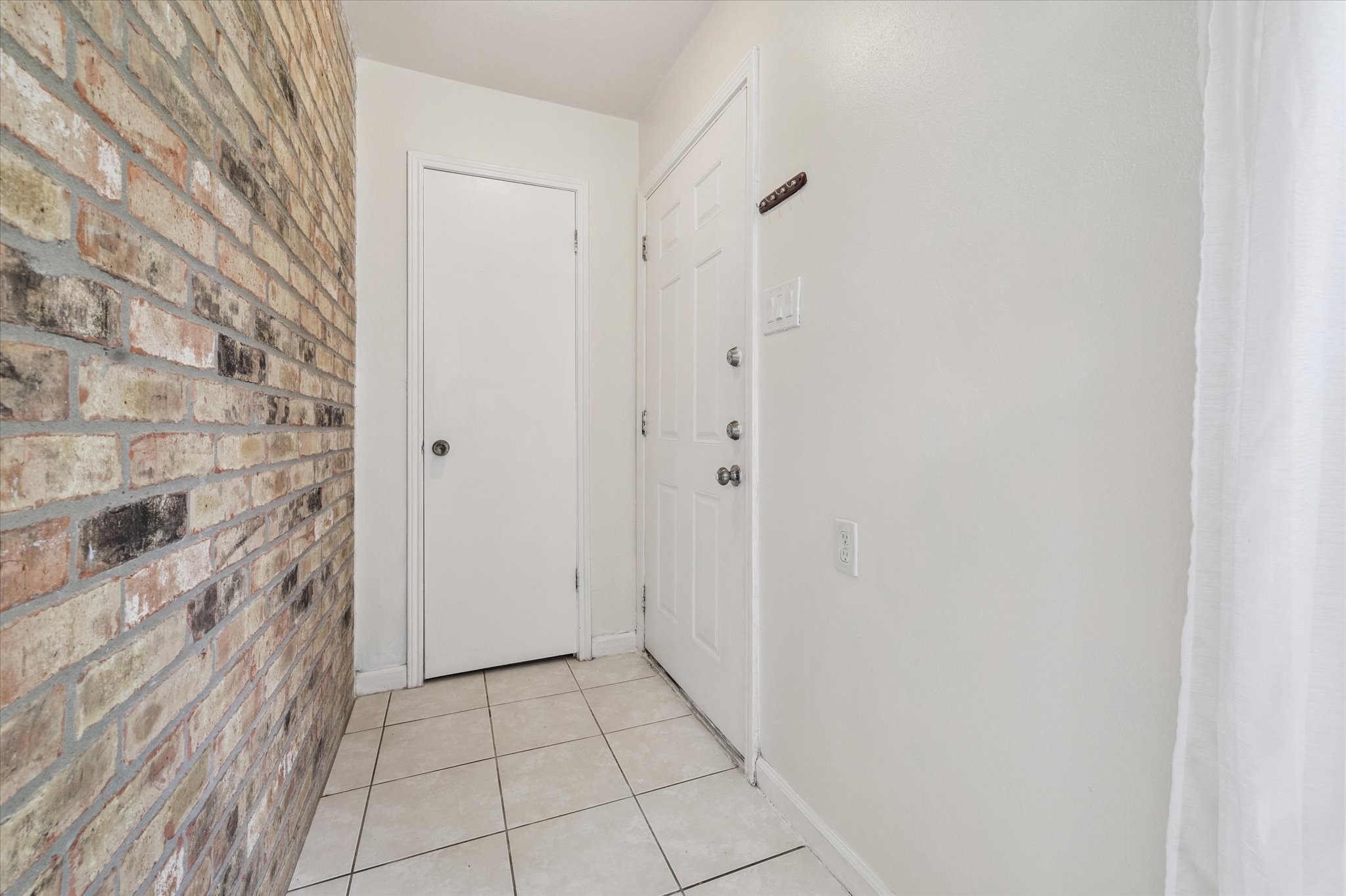 6517 Wanda Lane Houston, TX 77074 - Photo 3 of 29 An entryway with a brick accent wall creates an inviting welcome for your guests. A coat closet is great for extra storage space.
