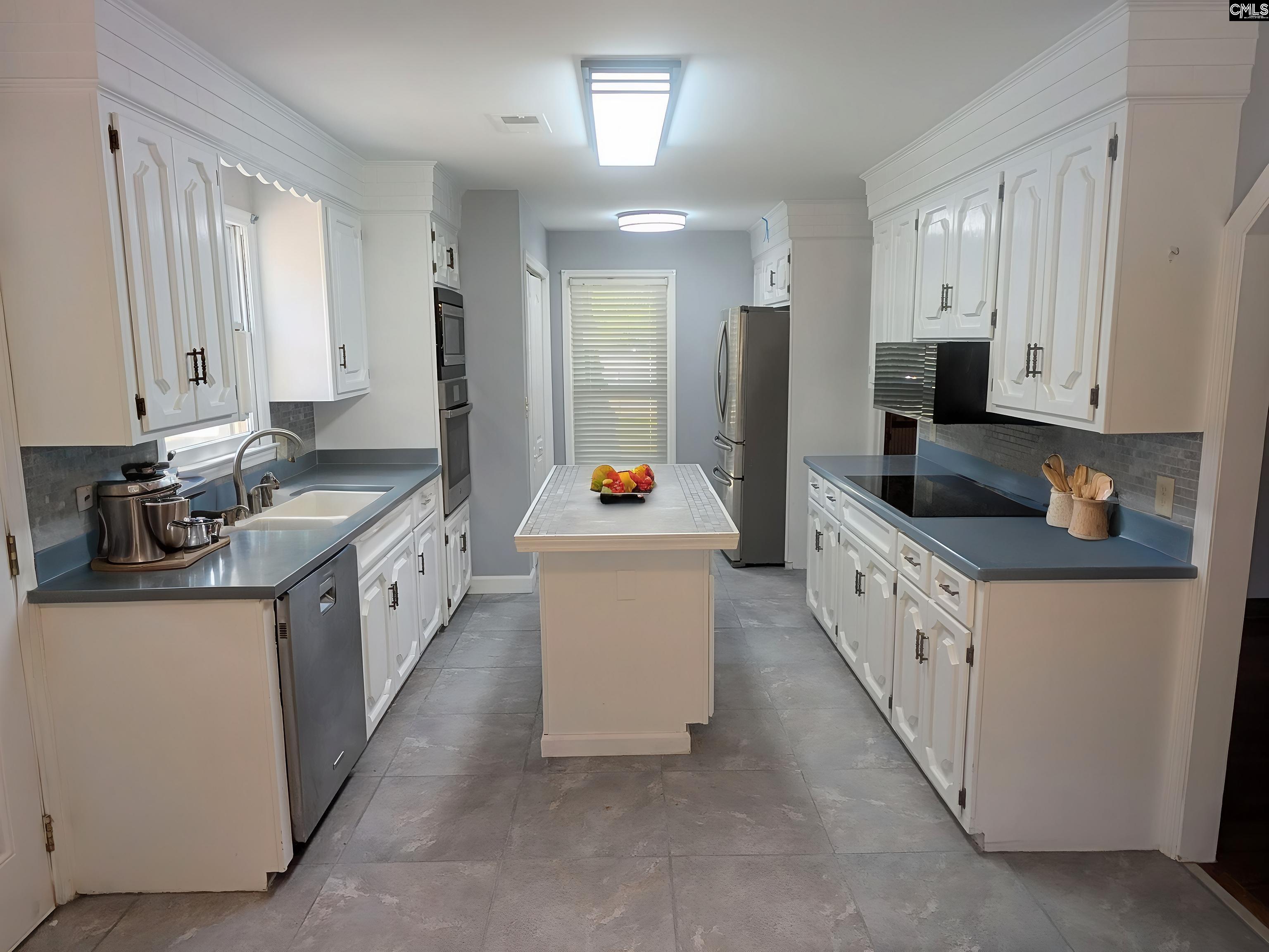 100 Welsh Court Lexington, SC 29073 - Photo 6 of 27 a kitchen with stainless steel appliances kitchen island granite countertop a sink stove and cabinets